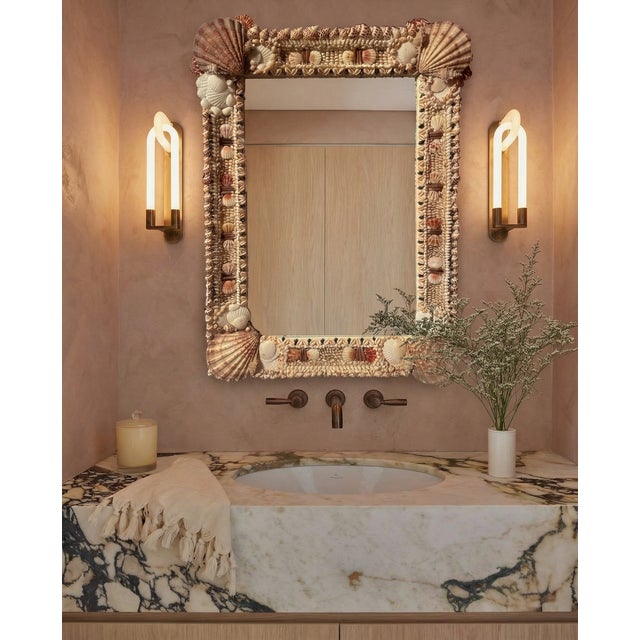 Truly one of a kind, this handmade shell mirror is meticulous in pattern and poise. This particular mirror is sized as...