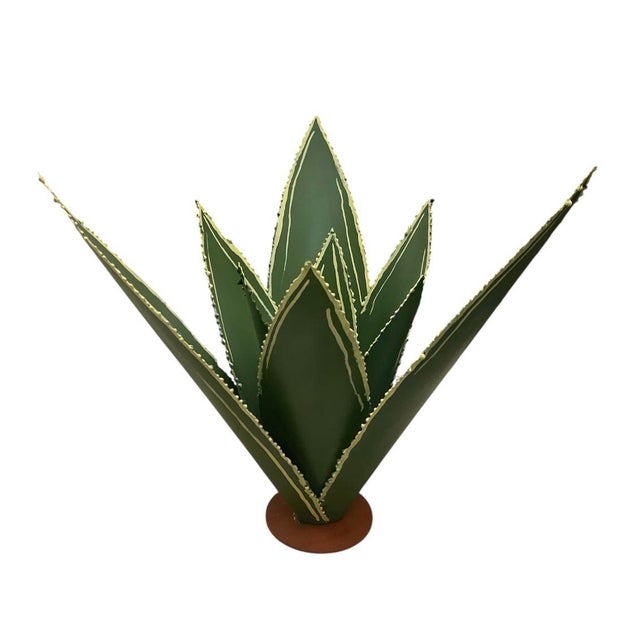 A striking, artisan-crafted metal architectural sculpture depicting a stylized agave plant, hand-formed and meticulously...