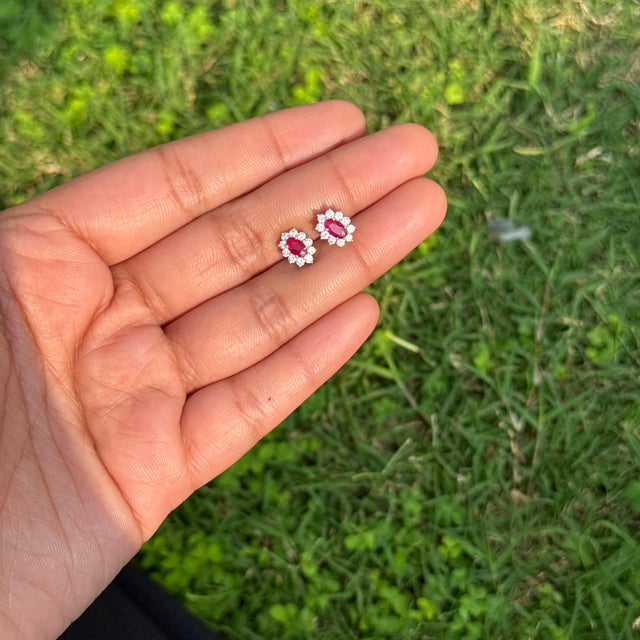 These cluster stud earrings featuring a 0.53 carat oval-cut ruby and diamond, set in in 14K yellow gold. The rubies...