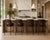 An elegant set of four authentic Barbara Barry for McGuire bar stools featuring woven caned backs, sculptural curved arms,...