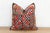 This 16-inch square pillow is a breathtaking fragment of Rajasthani heritage, repurposed from antique Banjara textiles...