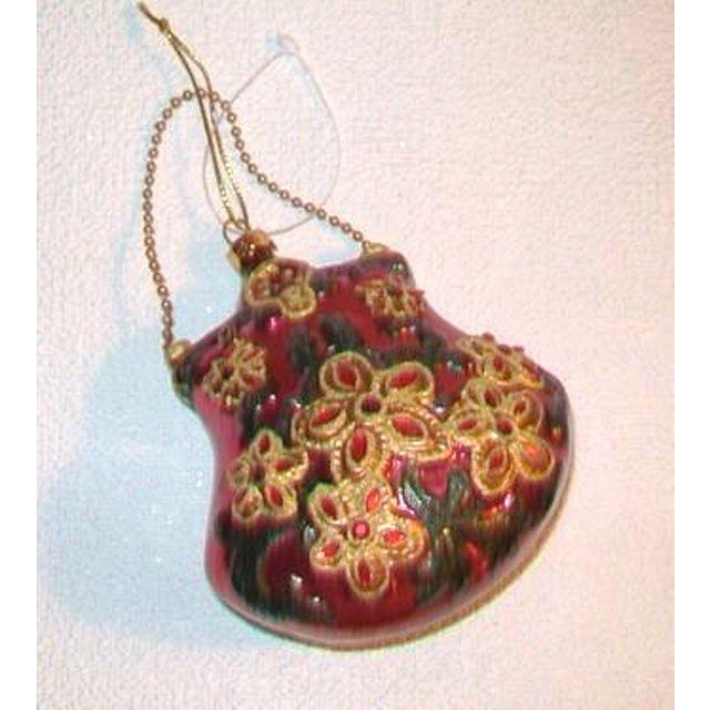 A darling Victorian style purse blown glass ornament with faus beaded flowers and a gold chain strap. The ornament...