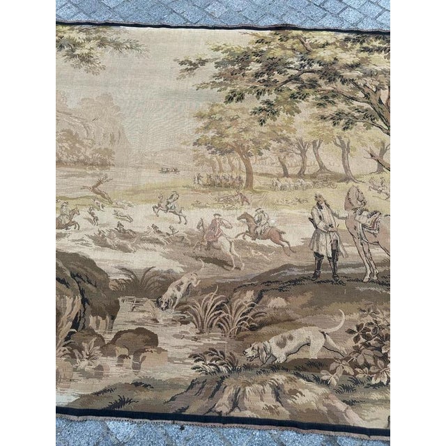 Timeless elegance of this exquisite vintage French tapestry featuring a hunting with hounds scene. A noble pastime and a...