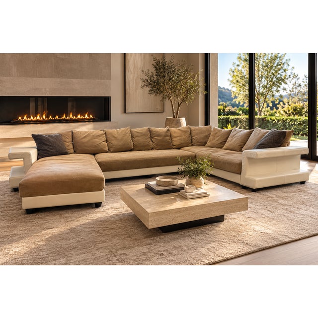 A monumental Roche Bobois sectional combining sculptural white leather framing with warm taupe-beige suede seating and...