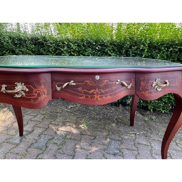 This elegant circa 1960 French Louis XVI writing desk combines classical neoclassical proportions with the warmth of...