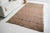 This is a vintage Turkish Oushak rug from the Mid 20th Century. The piece was hand-knotted.