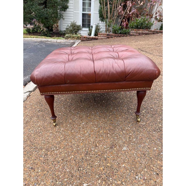 Old school charm at its best! This classic, tufted, oxblood leather ottoman elevates any space with nailhead trim and...
