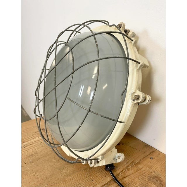 Vintage industrial cast iron wall lamp made by Elektrosvit in former Czechoslovakia during the 1970s. It features a cast...