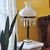 Striking vintage interpretation of a 19th-century Sinumbra/Astral lamp, featuring a fluted dark bronze/brass-tone column...