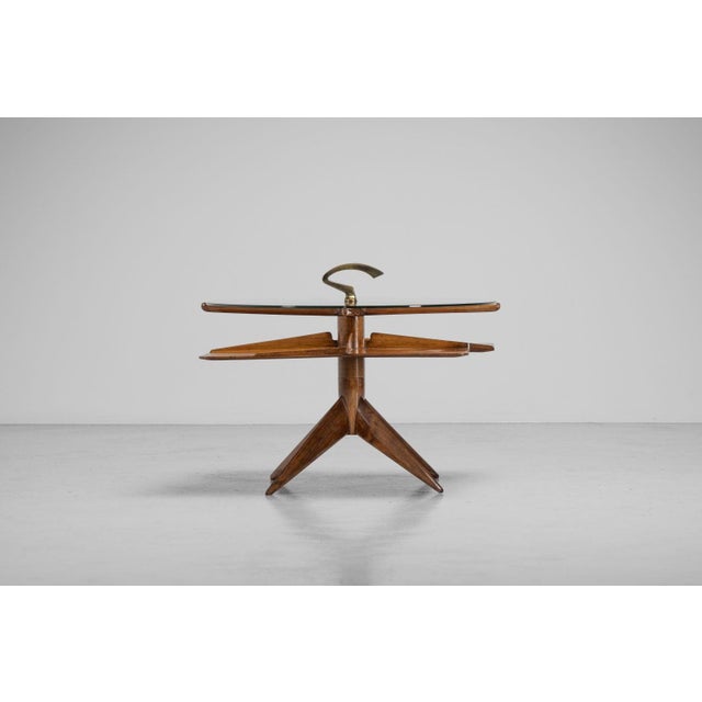 An exceptional and rare revolving side magazine table of unknown authorship, made in Italy 1950s. Yet crafted with a level...