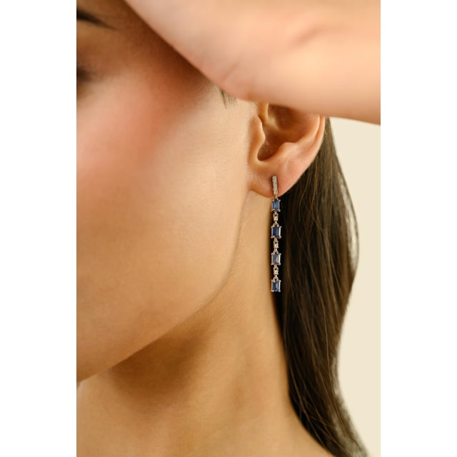 These contemporary linear drop earrings feature 8 octagon cut blue sapphire totaling 1.78 carats, set in rich 14k white...