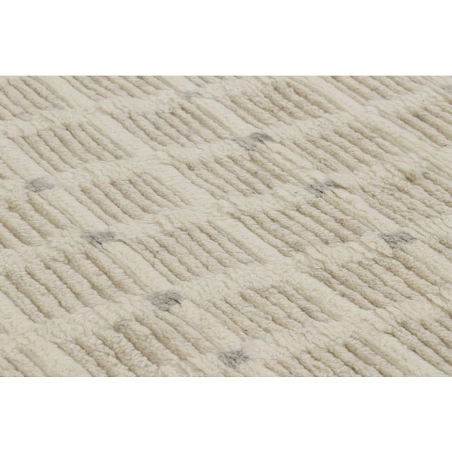 Hand-knotted in wool, this 8x10 textural rug by Rug & Kilim features variations in color and pile height which lend a...
