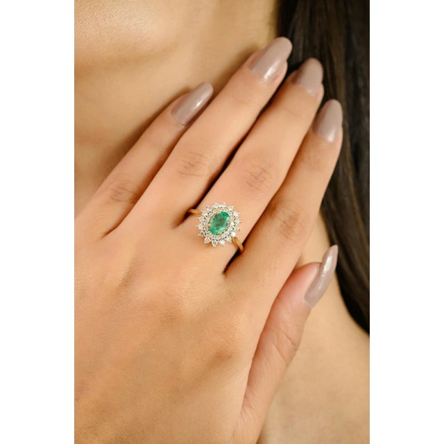This Vintage 18k Yellow Gold Emerald & Halo Diamond Cluster engagement Ring, masterfully crafted in luxurious 18k yellow...
