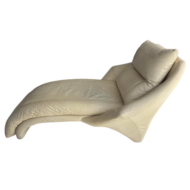 This is a Postmodern chaise lounge chair, designed by Roger Rougier in the 1980s. It is highly padded with wing-like arms,...