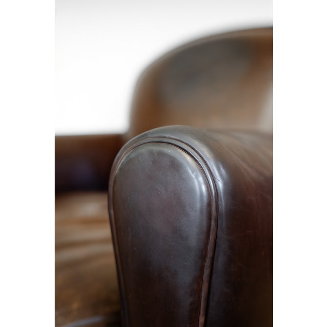 This Baron club chair, with its distinctive character, captivates with the softness of its full-grain sheepskin leather....