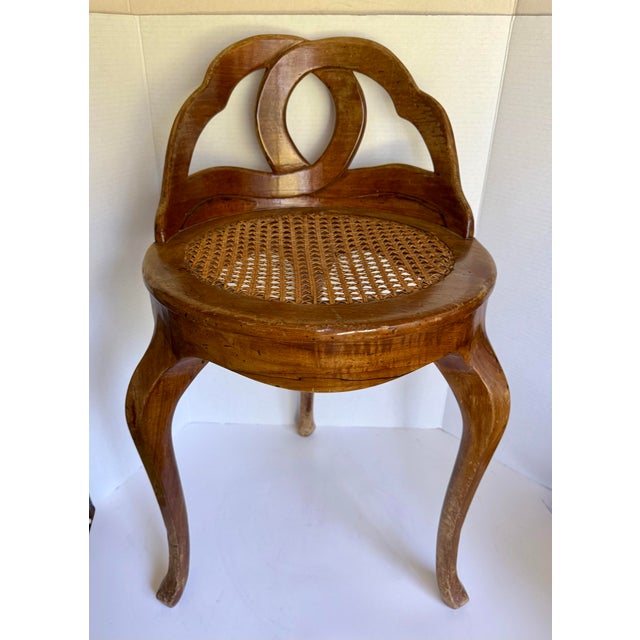 Here is a beautiful vintage Italian caned vanity chair, made in the early-20th century and inspired by Venetian forms. It...