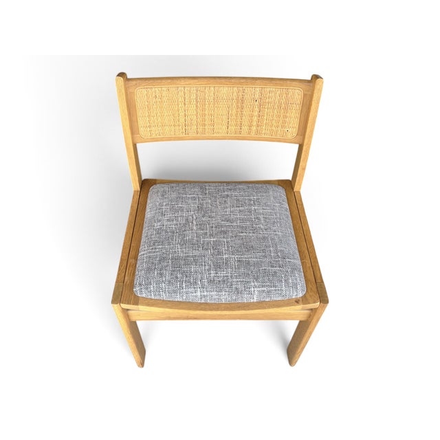 With their warm teak frames, woven cane backs, and tailored gray upholstery, this set of six vintage Soro Stole dining...