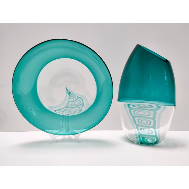Made in Italy, 1970s - 1980s. It is made in teal and clear Murano glass with inclusions of puff-expanded murrines, This is...
