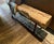 Authentic reclaimed timber beam bench with incredible natural patina, weathered surface movement, and deep age checking...