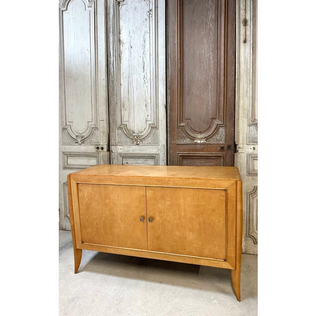 Sycamore veneer sideboard from the 1930s-40s. It opens with two doors and bronze knobs. The semicircular uprights...
