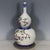 A beautiful Chinese porcelain double gourd vase. The vase features a white ground decorated with vibrant Famille Rose...