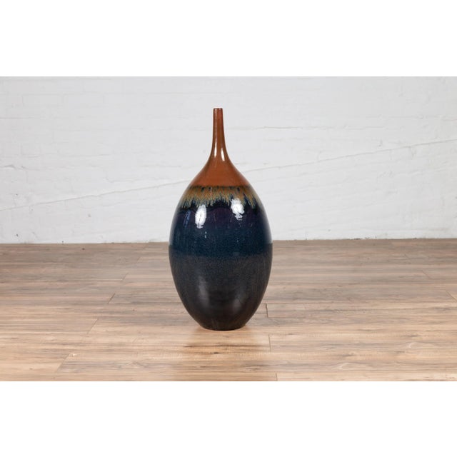 A vintage northern Thai Chiang Mai blue and brown vase from the Prem collection with tapered neck and golden dripping...
