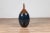 A vintage northern Thai Chiang Mai blue and brown vase from the Prem collection with tapered neck and golden dripping...