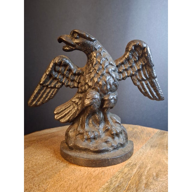 For sale is a 1920s–1930s Early American cast iron doorstop depicting a bold American Bald Eagle perched atop a rocky...