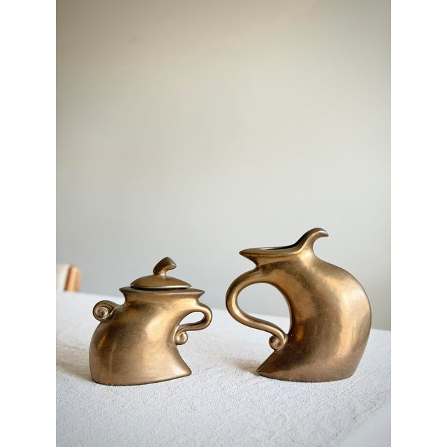 1980s sculptural ceramic tea set by California artist Michael Lambert, executed in his signature anthropomorphic...