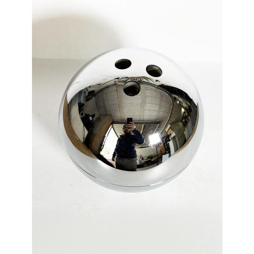 Vintage chrome ice bucket with an iconic spherical design reminiscent of the 1970s. Its perfectly round shape and mirrored...