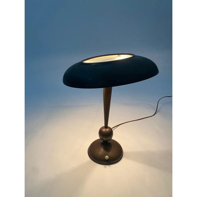 Rare and refined table lamp designed by Oscar Torlasco for the "Lumi" company in Milan. The hat can be tilted to shield...