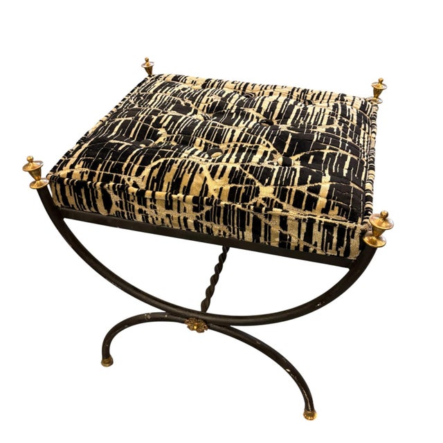 Neoclassical bench with black lacquered metal legs and gilt bronze finials. The seat is padded and upholstered in a black...