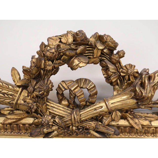 A striking late 19th century giltwood mirror executed in the refined Neoclassical taste, distinguished by its beautifully...