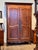 An 18th century Louis XV provincial armoire, the two shaped raised-panel doors with long pierced steel escutcheons and a...