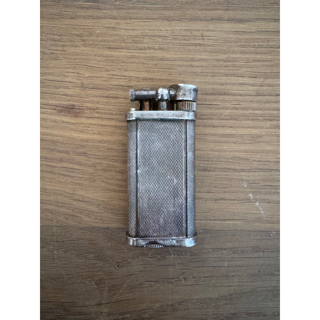 Vintage silver lighter, made in England. This piece is subtly engraved with a P.I.W on the top from its original owner....