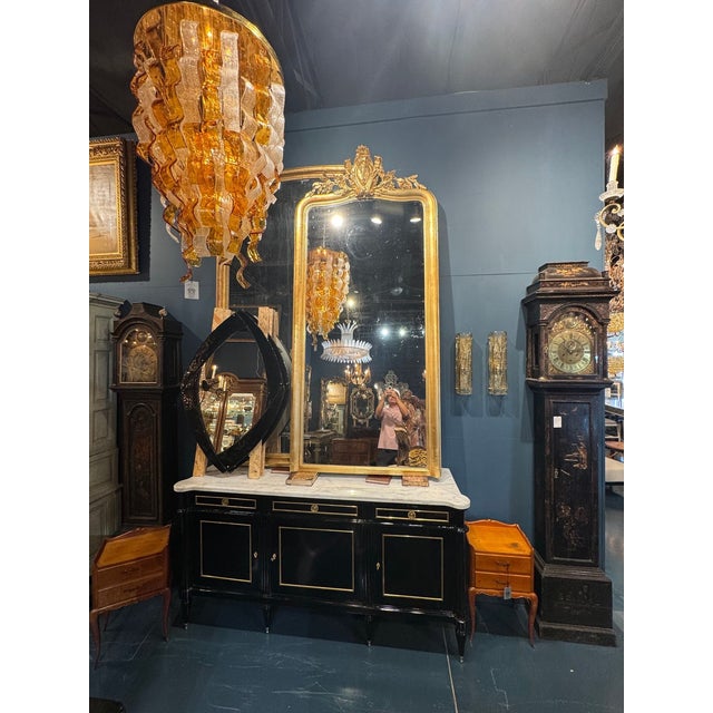 This product is an elegant 19th century French Louis XVI giltwood floor mirror, suitable for a grand entryway. Featuring...