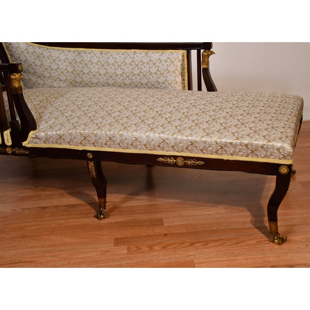 we are pleased to offer this gorgeous Antique French Empire chaise lounge, from the 1890s. This chaise is made of Mahogany...