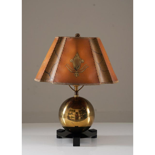 Charming art deco table lamp manufactured by Corona, Sweden, 1930s. The lamp consists of a large brass sphere with a round...