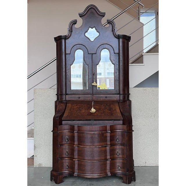 Italian Baroque style walnut veneer secretary cabinet, early 20th century. The top part of the cabinet over slant-front...