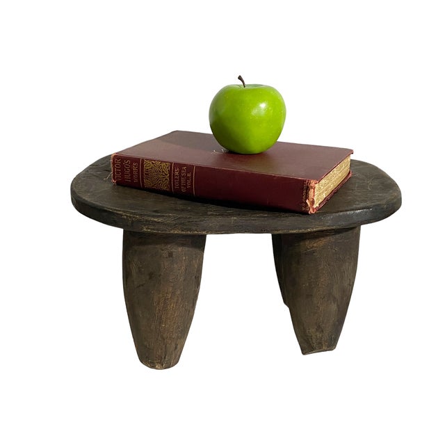 Superb vintage rustic look African Senufo milk stool on four tapered legs with an abstract form . Carved from one piece of...