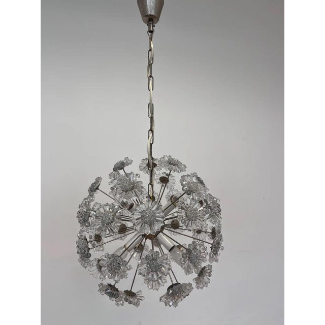 Distinctive 1970s chandelier with a dandelion-inspired form, combining cut glass elements and a chrome structure for a...