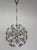 Distinctive 1970s chandelier with a dandelion-inspired form, combining cut glass elements and a chrome structure for a...
