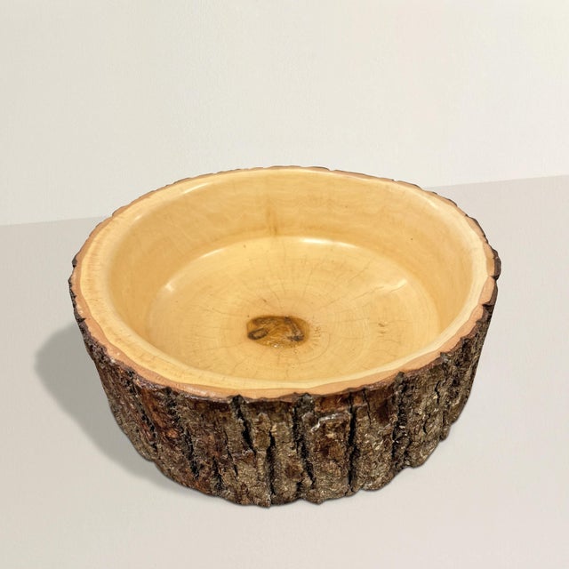 This hand-turned ash wood bowl, found in Wisconsin’s Door County, is a celebration of natural form and craftsmanship....