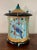 A whimsical and beautifully handcrafted decorative box featuring an elaborate faux birdcage design with richly layered...