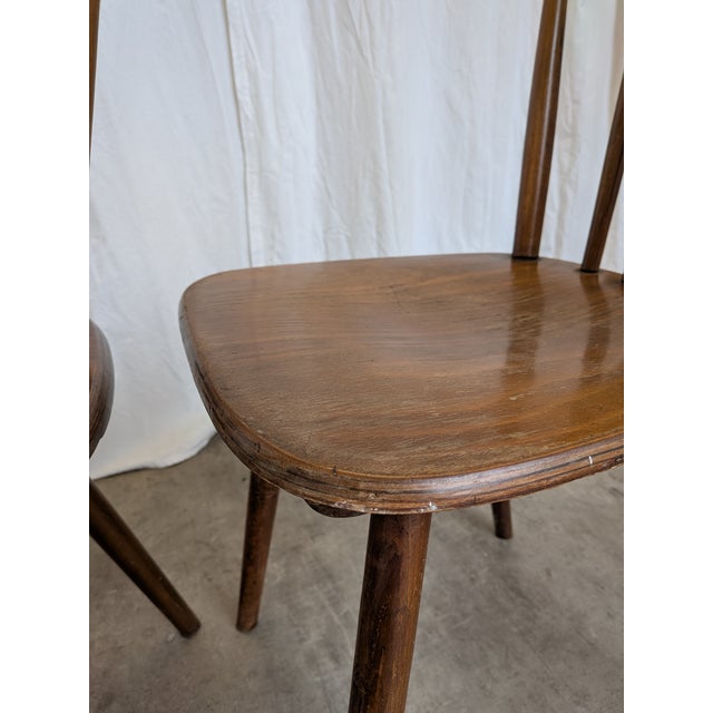 Set of four vintage wooden dining chairs produced by Stol Kamnik in former Yugoslavia, dating to the 1970s. Traces of...