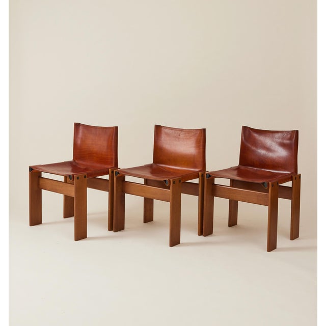 A set of 6 Italian 'Monk' leather dining chairs by Afra & Tobia Scarpa for Molteni. Designed in 1974, the Monk chair is...