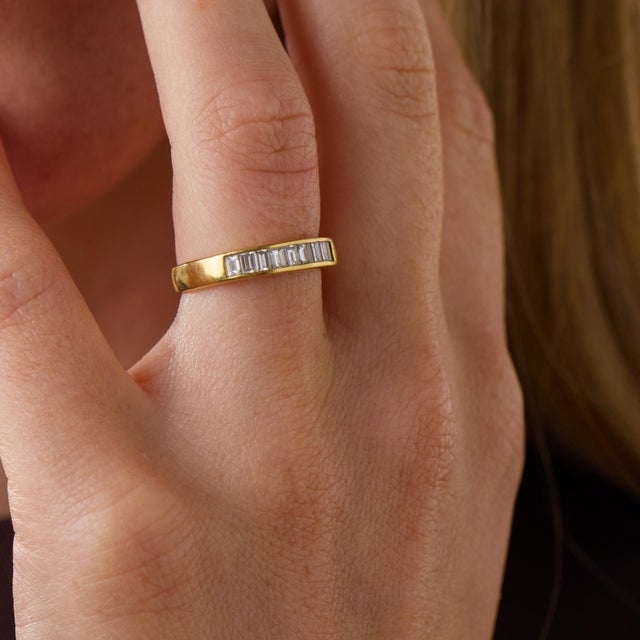 This elegant vintage diamond band is a beautifully balanced design from the 1970’s, set with 9 baguette cut diamonds...
