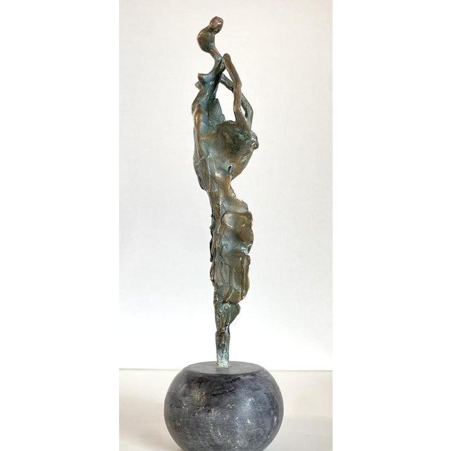 This shiny contemporary bronze sculpture of a dancer blends elegance with a playful, whimsical spirit. Slightly abstract...