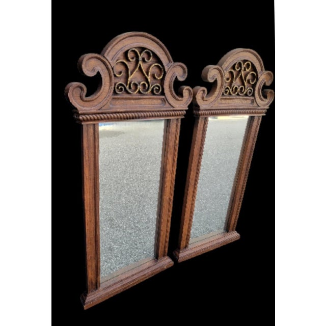 A wonderful pair of extra tall curvy pagoda style wall mirrors. The mirrors are in their original faux wood finish. The...