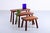 A set of three teak ( colored ) nesting tables. Robust appearance with no decorative elements, just an honest focus on the...